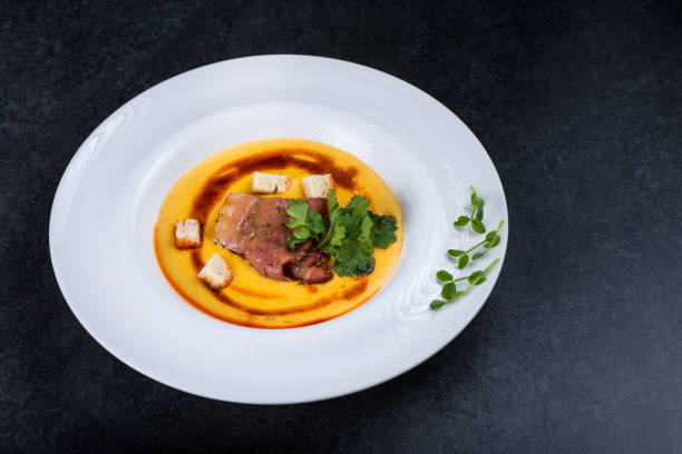 istock An appetizing pumpkin soup is served in a white plate in a restaurant 947213608