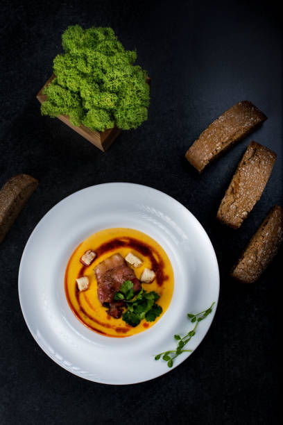 istock An appetizing pumpkin soup is served in a white plate in a restaurant 947215826