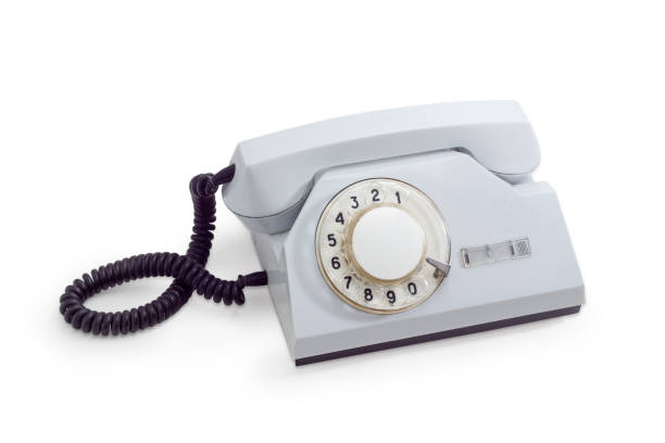 istock Old telephone set with rotary dial in white plastic housing 947216664