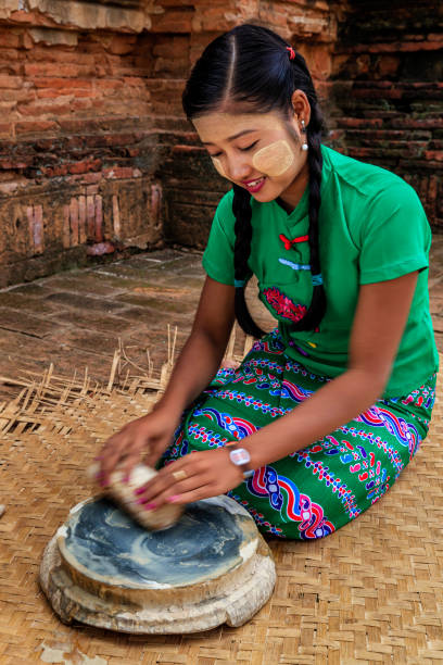 istock Young Burmese girl preparing thanaka paste in Bagan, Myanmar 947217722