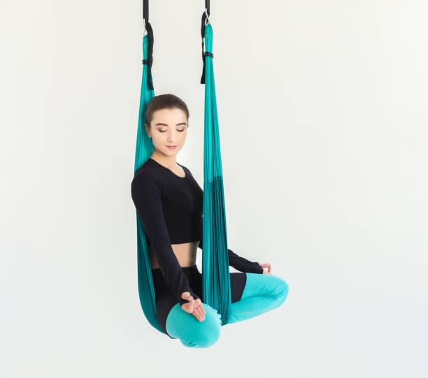 istock Woman practicing fly yoga over white background 947220248