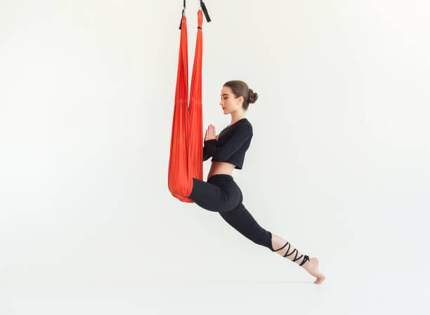 istock Woman practicing fly yoga over white background 947220308