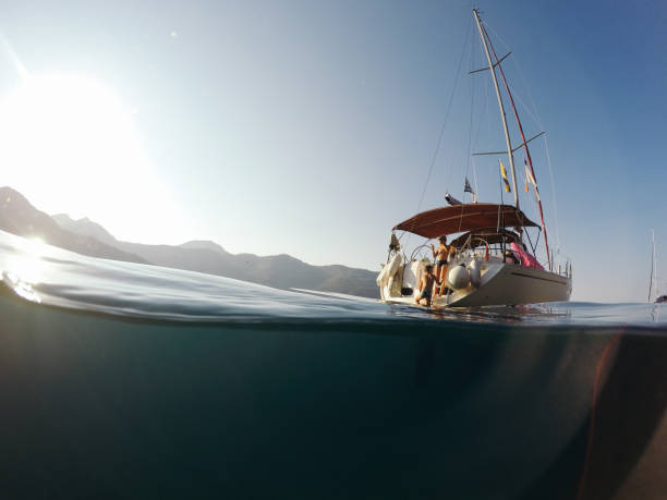 istock Children jumping into the water from yacht 947223678