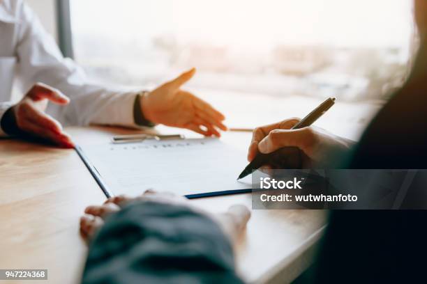 Dealer Sales Advice To The Customer And Guide To Sign The Contract Stock Photo - Download Image Now