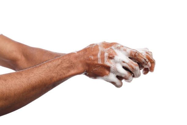 istock Black man washing hands isolated on white background 947224492