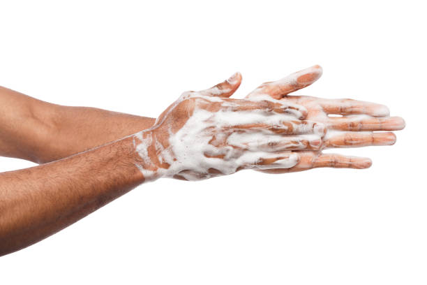 istock Black man washing hands isolated on white background 947224522