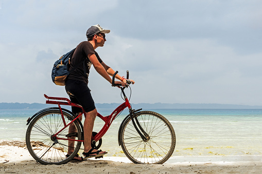 Ride on bike on the beach. Sport and active life concept. Ride on bike on the beach. Sport and active life concept