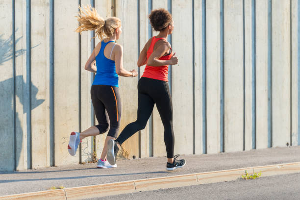 istock Two female athletes running together 947228118