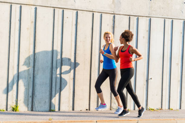 istock Two female athletes running together 947228122