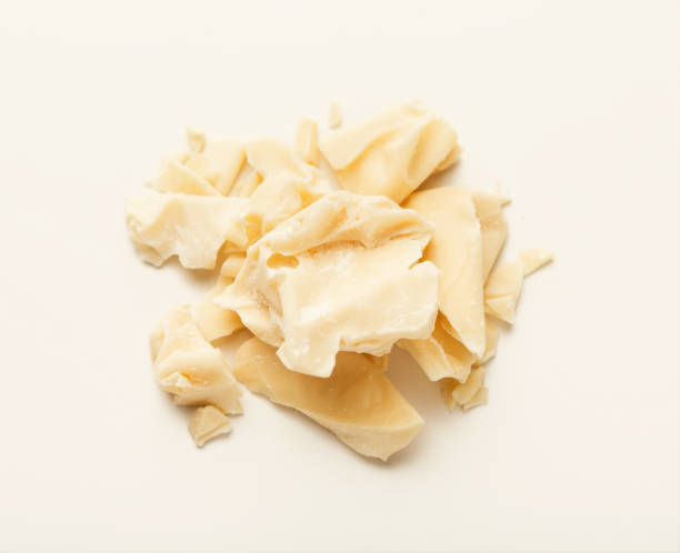Cocoa butter isolated on white Pieces of cocoa butter isolated on white background. Heap of white chocolate, cutout butter stock pictures, royalty-free photos & images