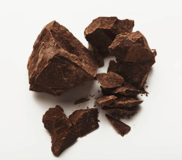 istock Heap of chocolate pieces isolated on white 947229104