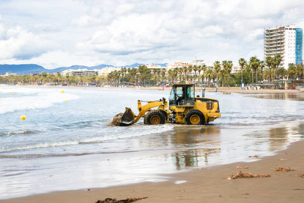 Tractor clean beach on coastline Costa Dorada, Salou, Spain stock photo