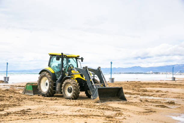 Tractor clean beach on coastline Costa Dorada, Salou, Spain stock photo