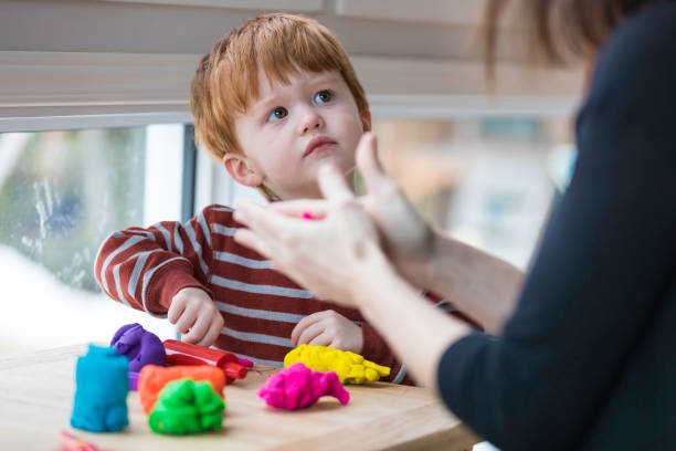 istock Mother and Son Playing with Child's Play Clay at Home 947229232
