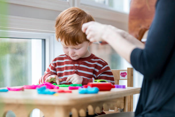 istock Mother and Son Playing with Child's Play Clay at Home 947229366