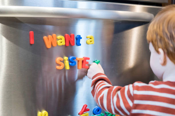 istock I want a sister message with Magnet Letters Text on Refrigerator 947229660