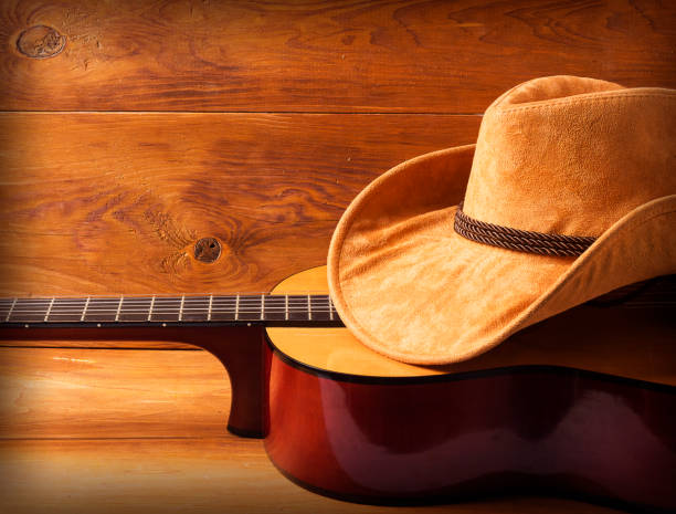 istock Guitar and cowboy hat on wood background 947230468