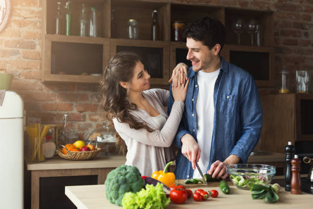 istock Happy couple cooking dinner together 947230600
