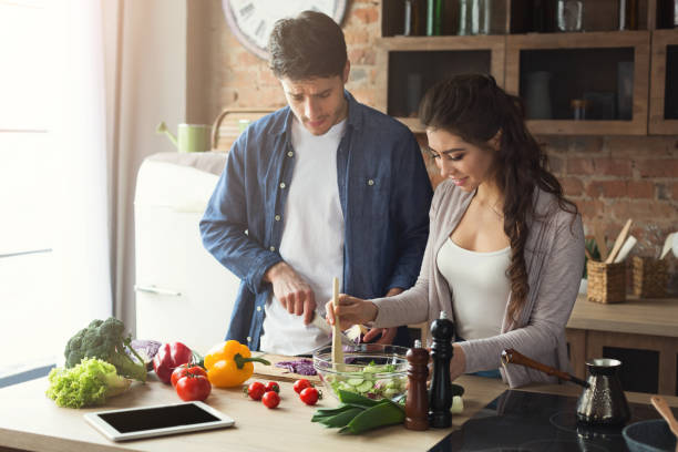 istock Happy couple cooking dinner together 947230728