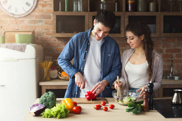 istock Happy couple cooking dinner together 947230776