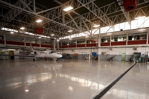 Private jet aircraft in the hangar awaiting regular maintenance service.
