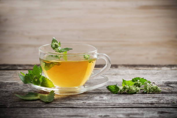 istock tea with melissa on old wooden background 947233104