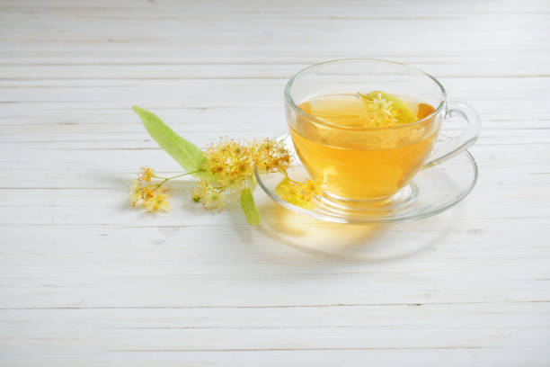 istock tea with linden on white wooden background 947233148