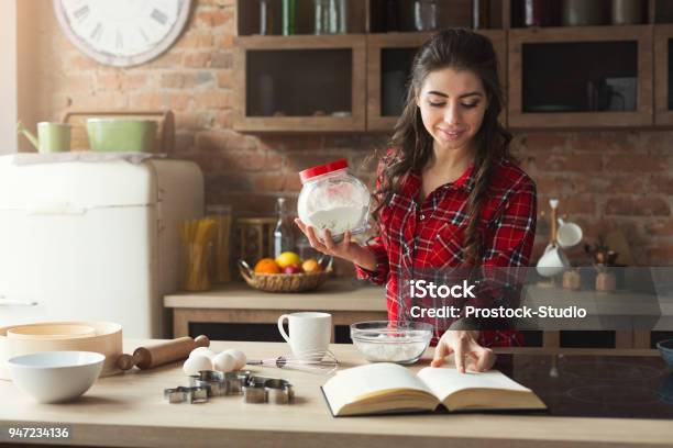 Happy Young Woman Baking In Loft Kitchen Stock Photo - Download Image Now - Cooking, Women, Baking