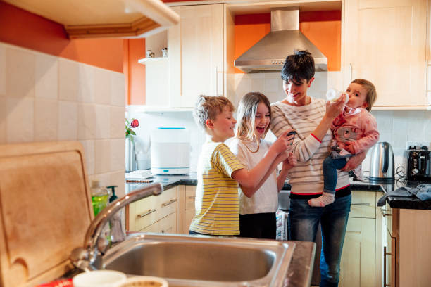 istock Multitasking Mum with her Children at home 947248776