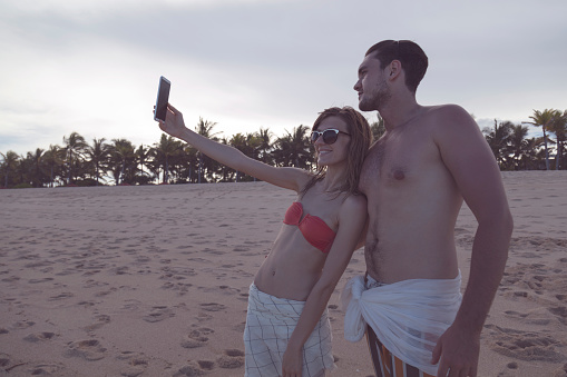 Couple doing a selfie on the tropical beach.