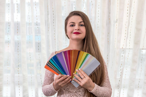 istock Smiling designer showing colour swatches in her hands 947256722