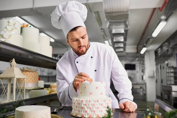 istock Confectioner with a cake in the bakery 947257026