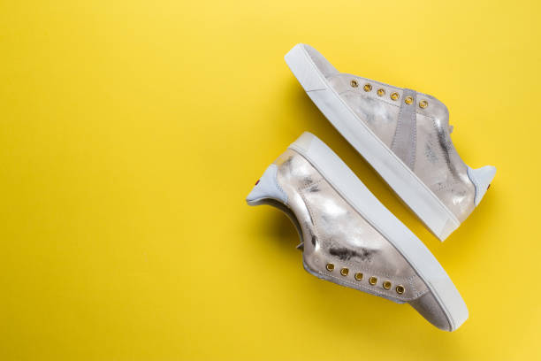 istock female spring sneakers on a yellow background 947259836