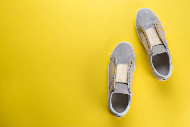 istock women's new sneakers on a yellow background, space for text 947259872