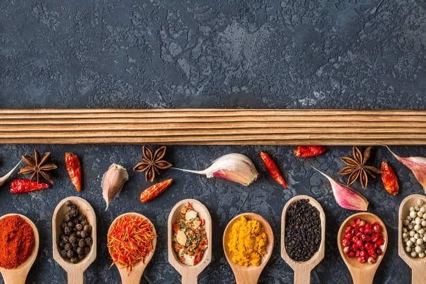 istock Various spices in spoons  on dark stone table. 947260172