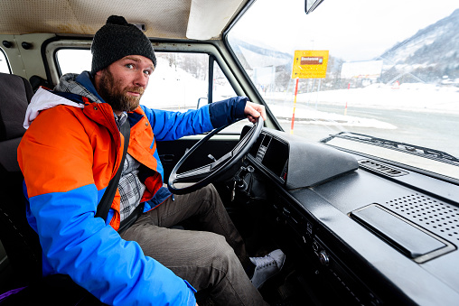 Interior view of delivery man driving a van or truck. Delivery logistics
cargo service old vintage truck driver in winter road traffic in Slovenia.