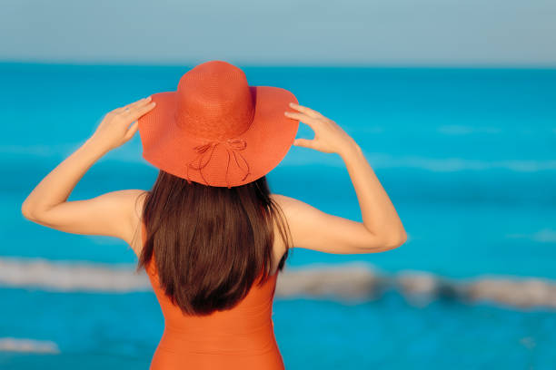 istock Summer Woman with Sunhat Looking at the Sea 947261284