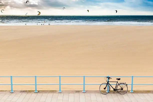 Bike at railings and kiters far off