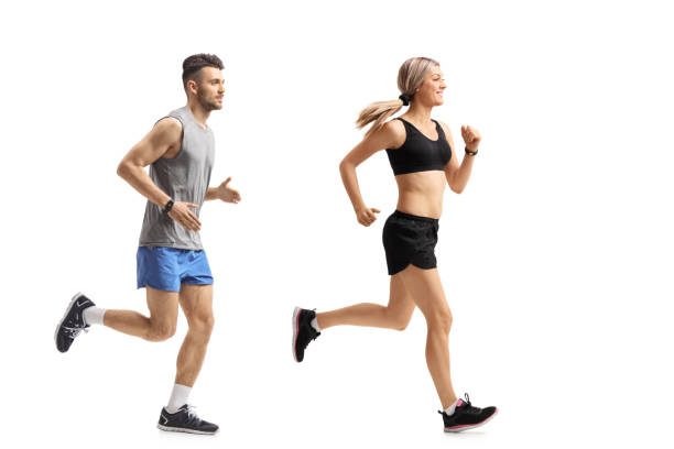 istock Young man and a young woman running 947263988