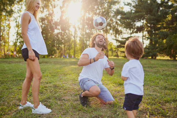 istock Family playing with a ball in the park 947264600
