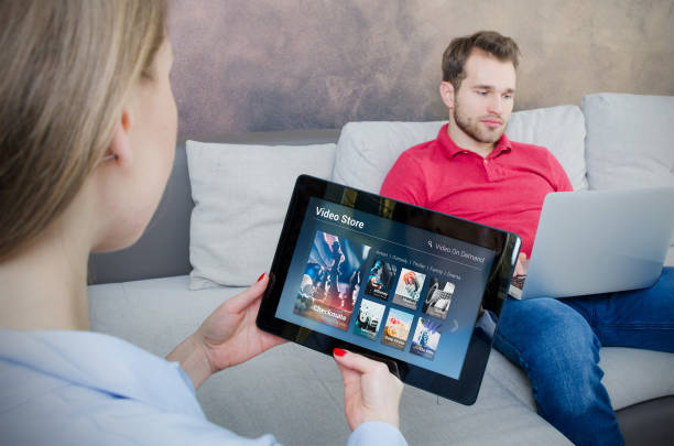 istock Woman using digital tablet for watching movie on VOD service 947264914