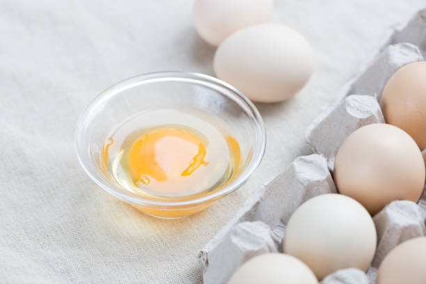 istock Fresh farm eggs. Egg yolk in glass bowl. 947264958