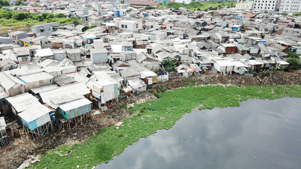 Crowded slum houses on the lakeside Aerial view of crowded slum houses on the lakeside at North Jakarta, Indonesia jakarta slums stock pictures, royalty-free photos & images