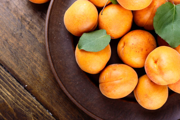 istock ripe apricots in a plate. 947268340