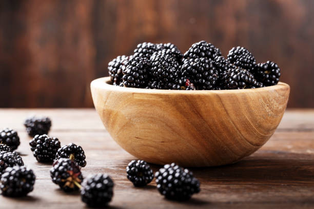 Fresh Harvest Blackberry Blackberry on a wooden background blackberry fruit stock pictures, royalty-free photos & images