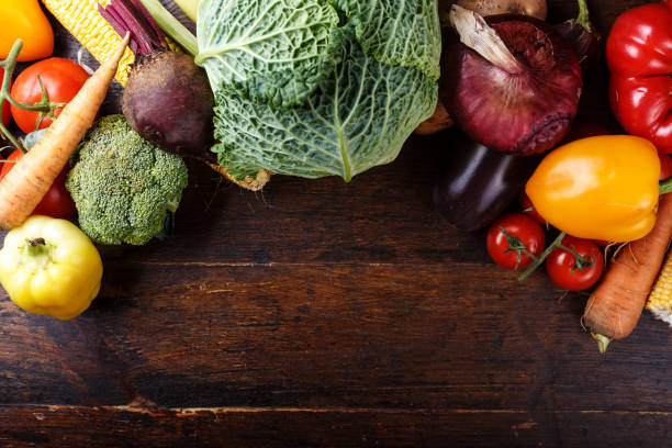 istock Summer vegetables on a brown wooden background. 947268892
