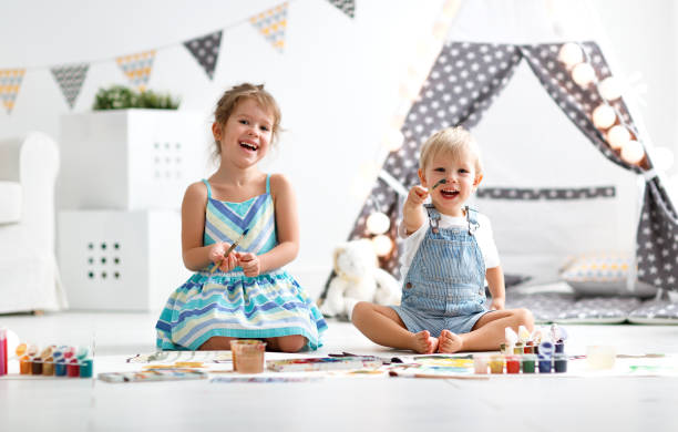 istock happy funny children paint with paint 947271344