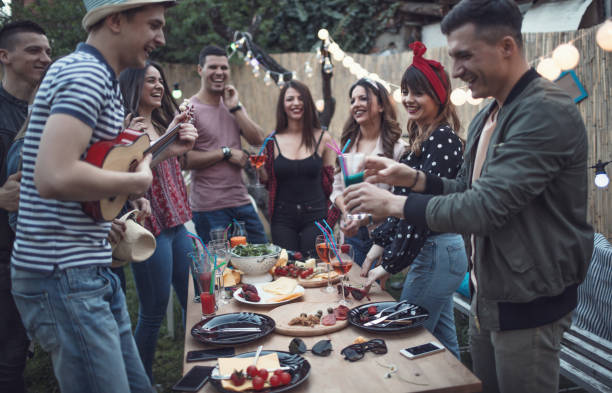 istock Group of friends having dinner party in backyard 947276238