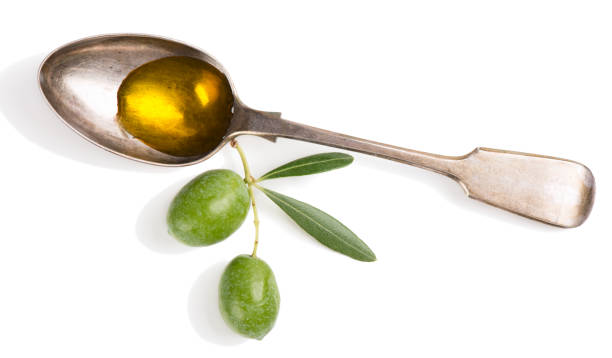 istock Olive oil and twig with olives. 947279096