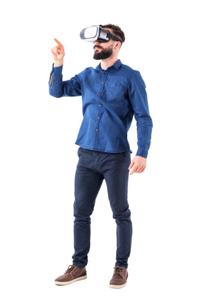 Young bearded business man wearing virtual reality using finger on augmented reality touch screen stock photo
